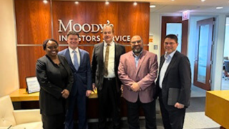 Image of Kacie Armstrong and David Piskac with members of Moody's Investors Services 