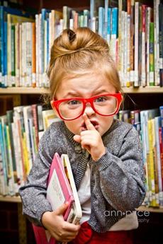 Little girl saying, "Shh"