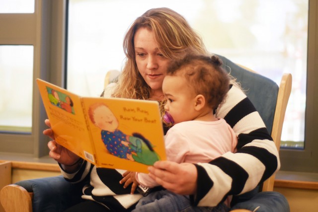 Mother reading to her baby