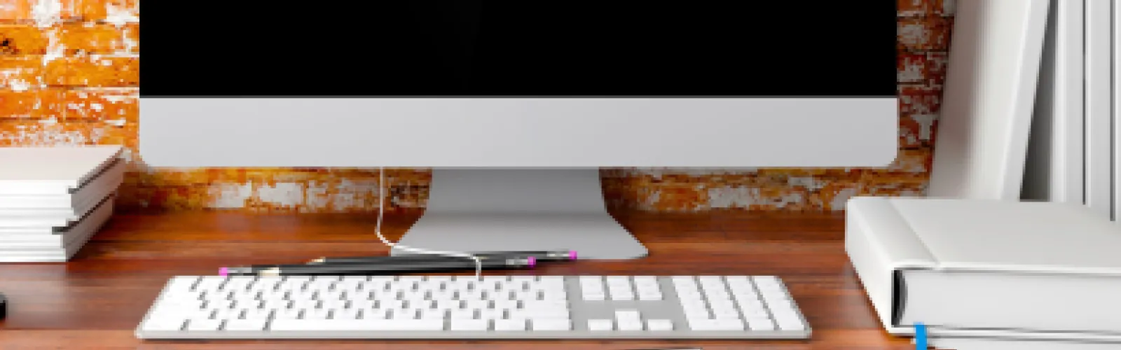 Close-up of a computer on a desk.