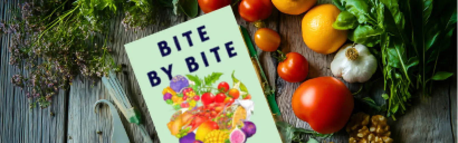 The book "Bite by Bite" surrounded by vegetables.