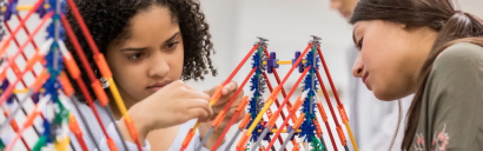 Photo of girl and woman building a bridge