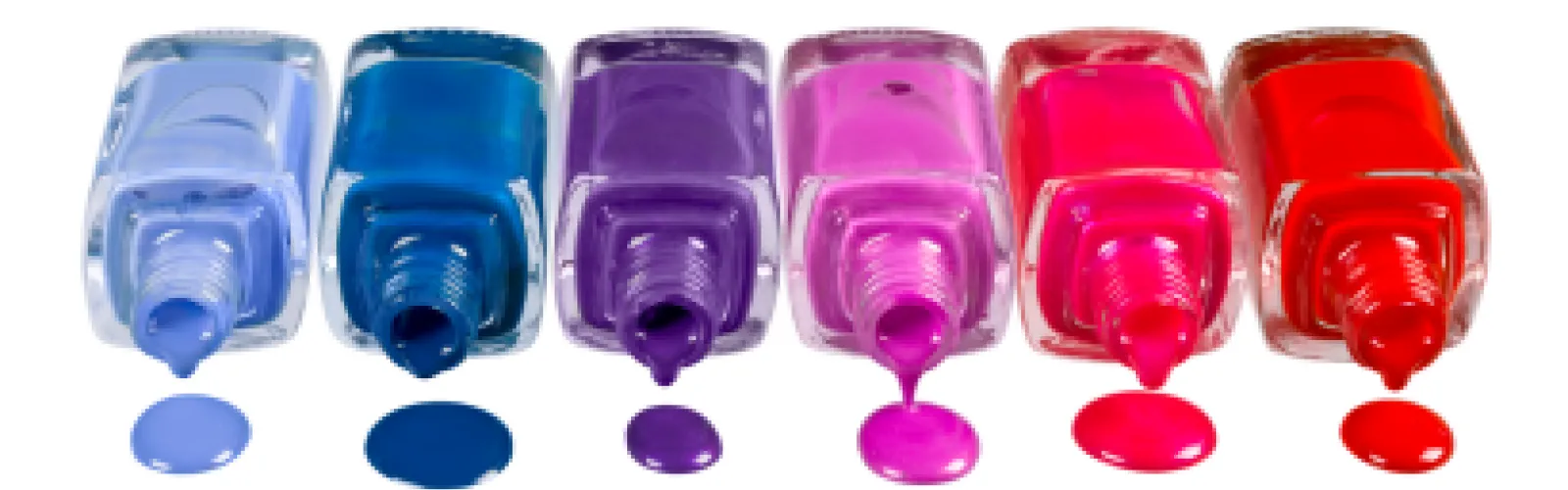 Different color nail polish on its side with polish dripping out