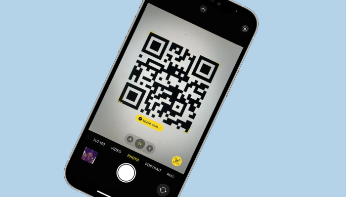 A QR code shown on a phone with a light blue background.