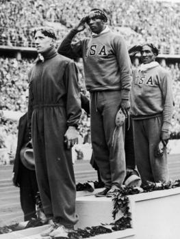 Jesse Owens on the medal podium at the 1936 Olympic Games